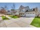 A beautiful house featuring manicured lawns and sidewalks leading up to the cozy covered front porch at 4219 Huntley Glen Dr, Pineville, NC 28134
