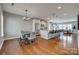 Spacious open-concept kitchen features stainless steel appliances, granite counters, and a large island with bar seating at 4219 Huntley Glen Dr, Pineville, NC 28134
