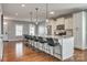 Expansive island with barstool seating in a large, open kitchen featuring sleek cabinets and stainless steel appliances at 4219 Huntley Glen Dr, Pineville, NC 28134