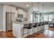 Open-concept kitchen with stainless steel appliances, granite countertops, and a large island with seating at 4219 Huntley Glen Dr, Pineville, NC 28134