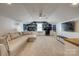 Spacious living room features a large sectional, a ceiling fan, and ample room for relaxing and entertaining at 4219 Huntley Glen Dr, Pineville, NC 28134