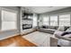 Cozy living room with a modern fireplace, a large sectional sofa, and plenty of natural light from bright windows at 4219 Huntley Glen Dr, Pineville, NC 28134