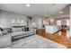 Open-concept living area showcases stylish furnishings, modern decor, and a seamless flow to the kitchen and dining spaces at 4219 Huntley Glen Dr, Pineville, NC 28134