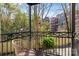 Balcony view with wrought iron railing and a woven chair with a lush, green fern at 4921 Park Rd # C, Charlotte, NC 28209