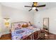 Bright bedroom with hardwood floors, large window, and stylish, colorful bedding at 4921 Park Rd # C, Charlotte, NC 28209