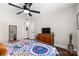 Bright bedroom with hardwood floors, large window, and stylish, colorful bedding at 4921 Park Rd # C, Charlotte, NC 28209