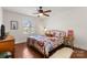 Bright bedroom with hardwood floors, large window, and stylish, colorful bedding at 4921 Park Rd # C, Charlotte, NC 28209