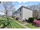 Exterior of a white brick home with blossoming trees and lush landscaping at 4921 Park Rd # C, Charlotte, NC 28209