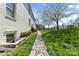 Charming exterior view showing the well-manicured lawn and sidewalk leading to the building at 4921 Park Rd # C, Charlotte, NC 28209