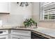 Kitchen sink with granite countertops, white subway tile, and modern faucet at 4921 Park Rd # C, Charlotte, NC 28209