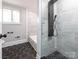 Modern bathroom featuring black and white mosaic-tiled floors and an updated shower at 5426 Milford Rd, Charlotte, NC 28210