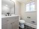 An updated bathroom features hexagon tile floors and modern vanity with marble countertops at 5426 Milford Rd, Charlotte, NC 28210