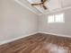 An empty bedroom features wood-look flooring and a ceiling fan with a modern light fixture at 5426 Milford Rd, Charlotte, NC 28210
