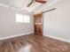 Bedroom with wood floors, ceiling fan and modern, sliding barn door to the closet at 5426 Milford Rd, Charlotte, NC 28210