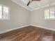 Cozy bedroom with hardwood floors, natural light, and ceiling fan at 5426 Milford Rd, Charlotte, NC 28210