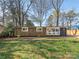 Charming home featuring a unique black and yellow striped design at 5426 Milford Rd, Charlotte, NC 28210