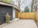 Exterior view of a home entrance showcasing a fenced entrance to a spacious concrete patio at 5426 Milford Rd, Charlotte, NC 28210