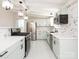 Modern kitchen with stainless steel appliances, light-green cabinets, and white marble backsplash at 5426 Milford Rd, Charlotte, NC 28210