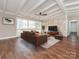 Bright living room with beamed ceiling, brick wall, and large windows at 5426 Milford Rd, Charlotte, NC 28210