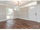 Bright living room featuring hardwood flooring, neutral walls, and modern light fixtures at 5426 Milford Rd, Charlotte, NC 28210