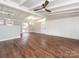 Spacious living room boasts hardwood floors, large windows, and exposed beam ceiling with fan at 5426 Milford Rd, Charlotte, NC 28210
