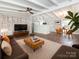 Bright and welcoming living room featuring hardwood flooring, an exposed beam ceiling and modern decor at 5426 Milford Rd, Charlotte, NC 28210