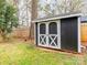 Backyard featuring a black storage shed with white trim and double doors at 5426 Milford Rd, Charlotte, NC 28210