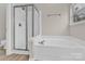 Bright bathroom featuring a soaking tub and glass shower at 5923 Carriage Oaks Dr, Charlotte, NC 28262