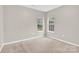 Bedroom with neutral carpet and two windows at 5923 Carriage Oaks Dr, Charlotte, NC 28262