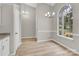 Bright dining area features a large window, contemporary chandelier and new flooring at 5923 Carriage Oaks Dr, Charlotte, NC 28262