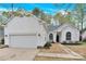 Charming one-story home featuring a two-car garage, arched windows and new landscaping at 5923 Carriage Oaks Dr, Charlotte, NC 28262