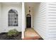 Charming covered front porch and black front door and arched window at 5923 Carriage Oaks Dr, Charlotte, NC 28262