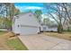 Side view of a single story home featuring garage and large driveway at 5923 Carriage Oaks Dr, Charlotte, NC 28262