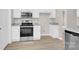 Well-lit kitchen with stainless steel appliances, white cabinetry, and stone countertops at 5923 Carriage Oaks Dr, Charlotte, NC 28262