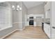 Open kitchen and dining area with stainless steel appliances, white cabinets and updated flooring at 5923 Carriage Oaks Dr, Charlotte, NC 28262