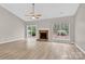 Spacious living room features a brick fireplace, ceiling fan and sliding door to the yard at 5923 Carriage Oaks Dr, Charlotte, NC 28262