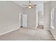 Bright main bedroom features neutral colors, carpet flooring, and a ceiling fan at 5923 Carriage Oaks Dr, Charlotte, NC 28262