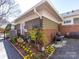 Backyard oasis offers lush landscaping, colorful flowers, custom pavers and a patio for entertaining or relaxing at 6301 Park South Dr, Charlotte, NC 28210