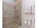 Stylish bathroom featuring glass-enclosed shower, shower bench and grab bars at 6301 Park South Dr, Charlotte, NC 28210