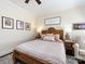 Cozy bedroom featuring a wooden bed frame, soft pink bedding, and neutral-toned walls at 6301 Park South Dr, Charlotte, NC 28210