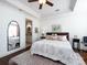 Spacious bedroom featuring tray ceiling, ceiling fan, and hardwood floors at 6301 Park South Dr, Charlotte, NC 28210