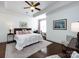 Bright primary bedroom with tray ceiling, ceiling fan, and hardwood floors at 6301 Park South Dr, Charlotte, NC 28210