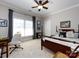 Bright bedroom with neutral walls, large window, and dark wood sleigh bed at 6301 Park South Dr, Charlotte, NC 28210