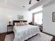 Light-filled bedroom with tray ceiling, ceiling fan, and large windows at 6301 Park South Dr, Charlotte, NC 28210