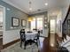 The bright dining area features stylish light fixtures, neutral paint and easy access to the outside at 6301 Park South Dr, Charlotte, NC 28210