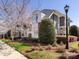 Exterior shot features an American flag, lush landscaping, and a classic street lamp at 6301 Park South Dr, Charlotte, NC 28210