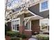 Charming home featuring neutral siding, brick accents, a covered entryway, and lush landscaping at 6301 Park South Dr, Charlotte, NC 28210