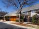 Exterior view of a two-story home with a detached garage, meticulously maintained landscaping, and private walkway at 6301 Park South Dr, Charlotte, NC 28210