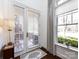 Bright foyer with views of the outdoors through large window and glass door at 6301 Park South Dr, Charlotte, NC 28210