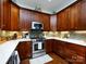A well-appointed kitchen offers stainless steel appliances, wood cabinetry, and sleek countertops at 6301 Park South Dr, Charlotte, NC 28210